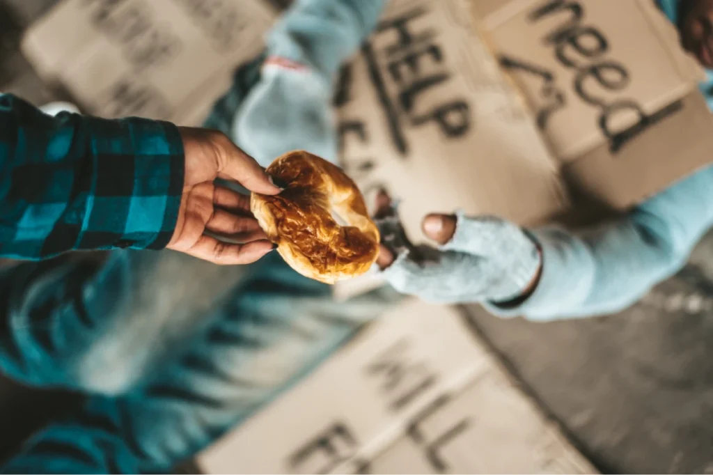 Handing food to a person in need.