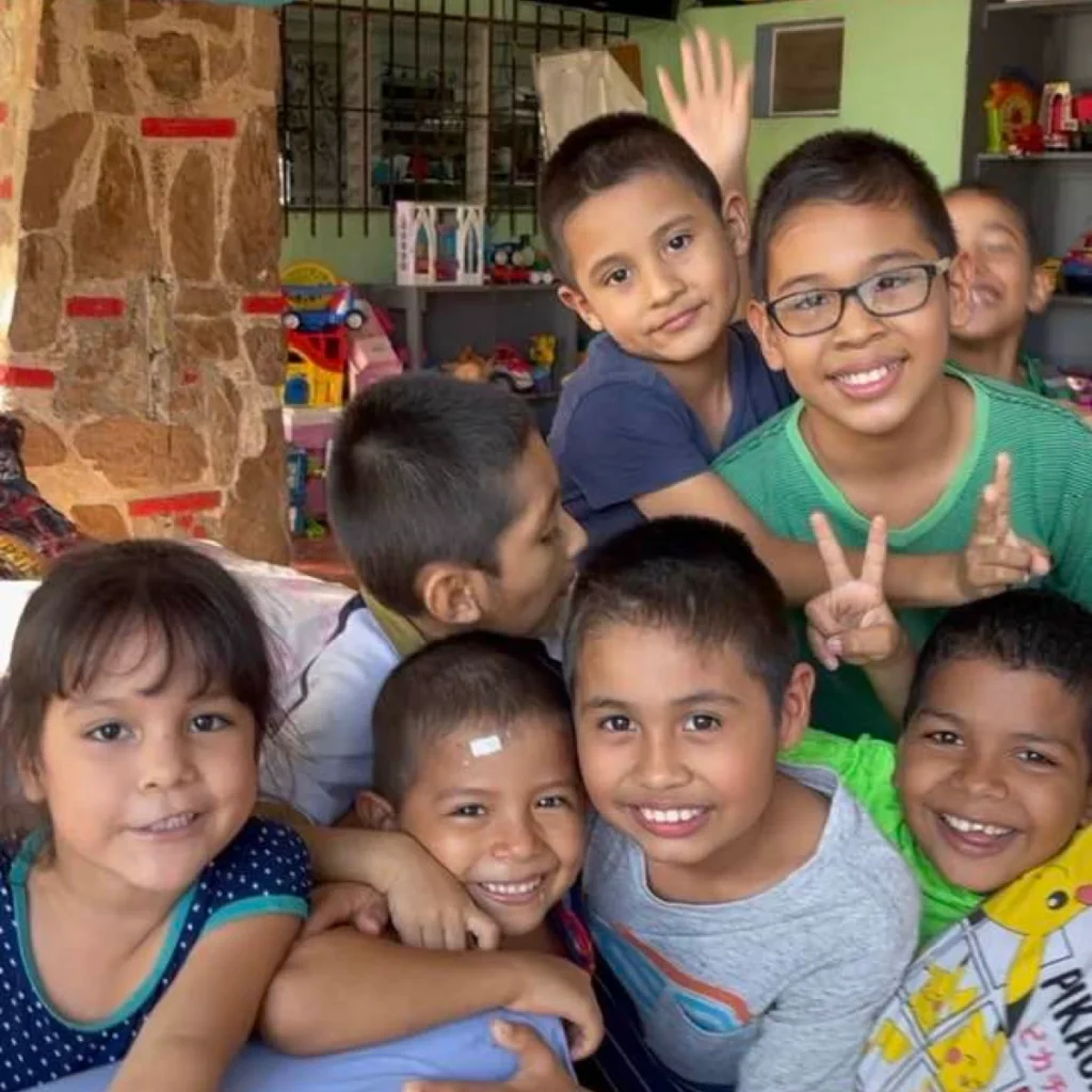 Smiling children posing together happily.