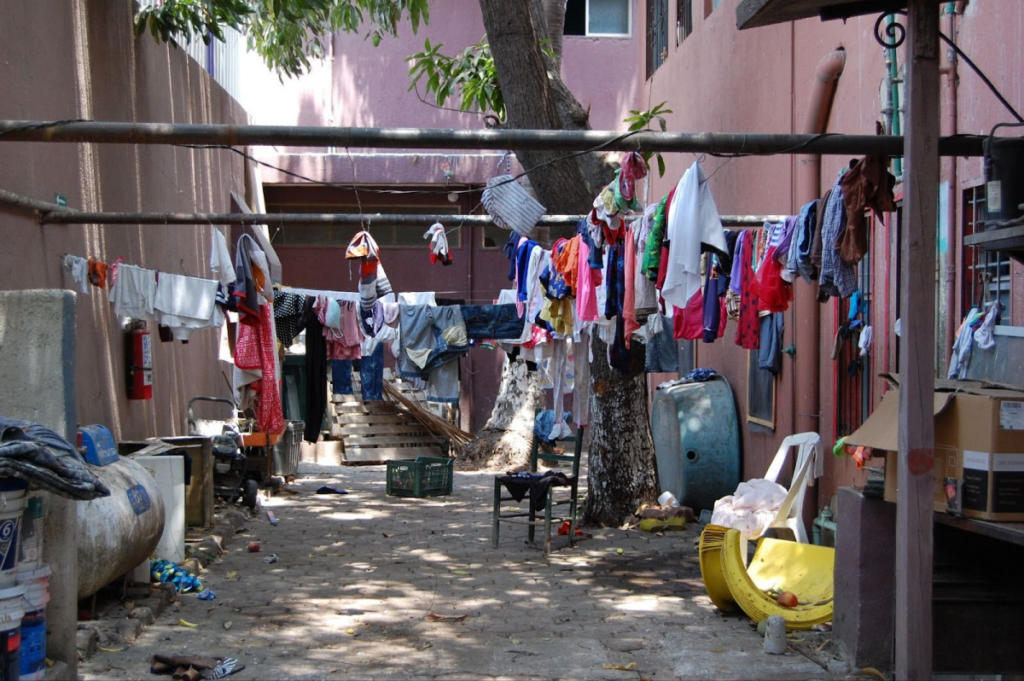 Clothes hung to dry in a communal outdoor space, signifying modest living conditions.