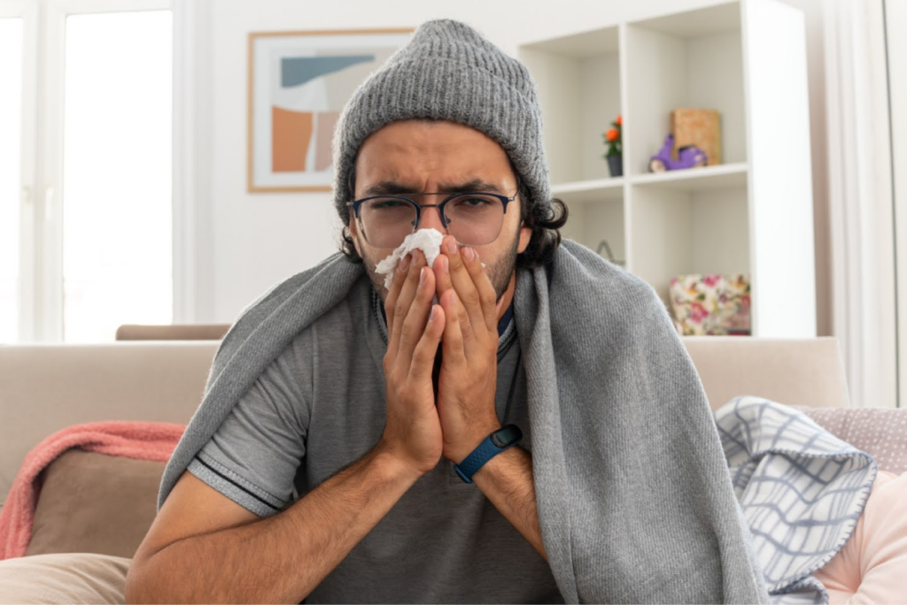 Sick man with tissue.