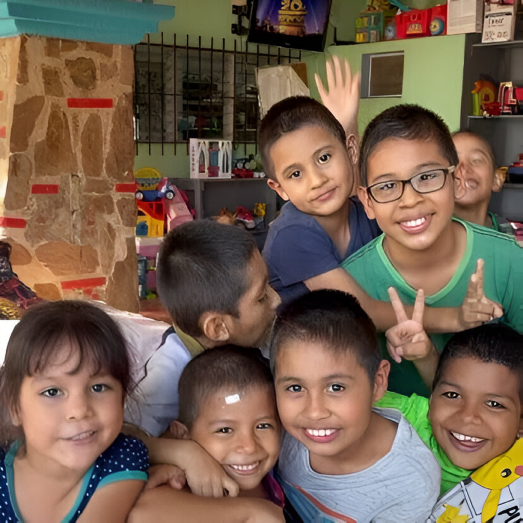 Group of smiling children posing for a group photo indoors